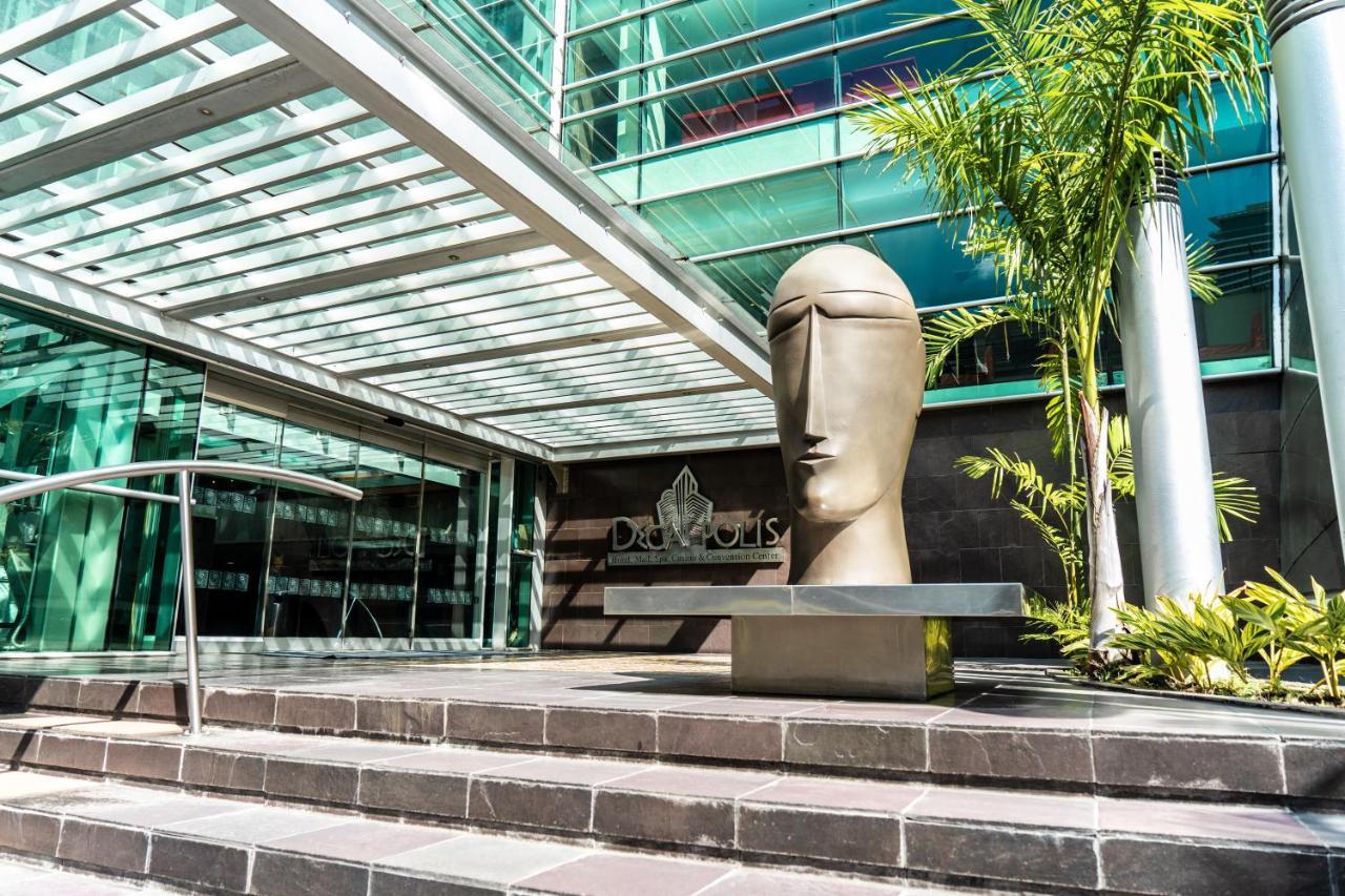 Decapolis Hotel פנמה סיטי מראה חיצוני תמונה The photo shows a modern architectural setting featuring a large, abstract sculpture of a head positioned on a stone step. The sculpture has a smooth, minimalist design, emphasizing a stylized face. Surrounding the sculpture are glass walls and an ov